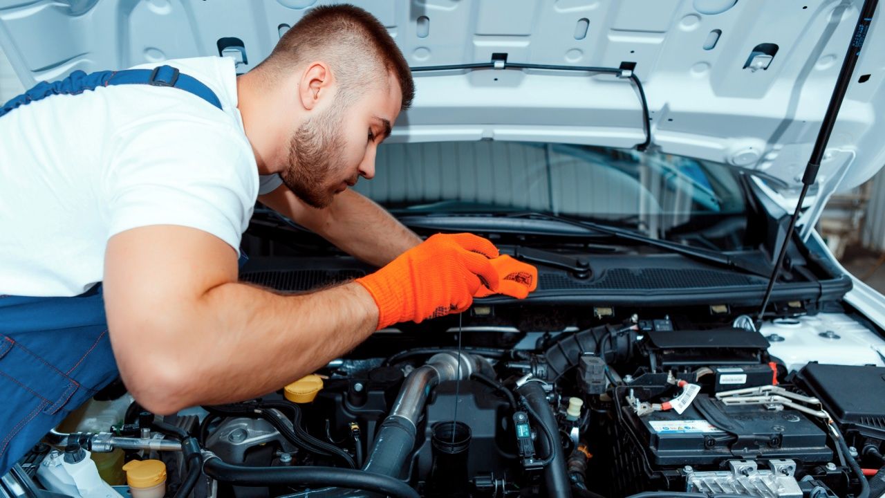 Un mecánico trabaja en el motor de un vehículo.