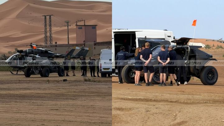 Dacia Sandrider de raids en en el desierto de Marruecos, con equipo técnico alrededor y un helicóptero de seguimiento presente.